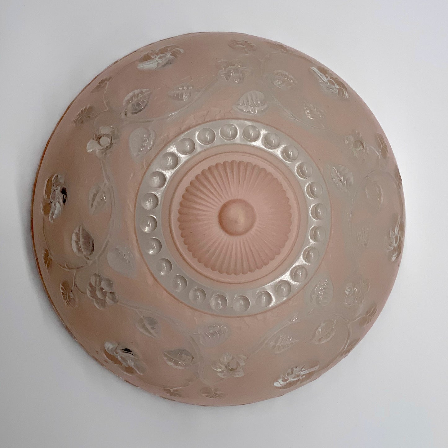 1945-1950's Post War Era Clear and Blush Pink Pressed Glass Ceiling Light Shade Features a center circular nipple style design adorned with a repeating flower and leaf pattern. Dusty pink is painted airbrushed on the outside and the embossed raised floral pattern is clear. 10.25 Diameter x 4" Deep Three Glass Hole Mounts No Chips or Cracks