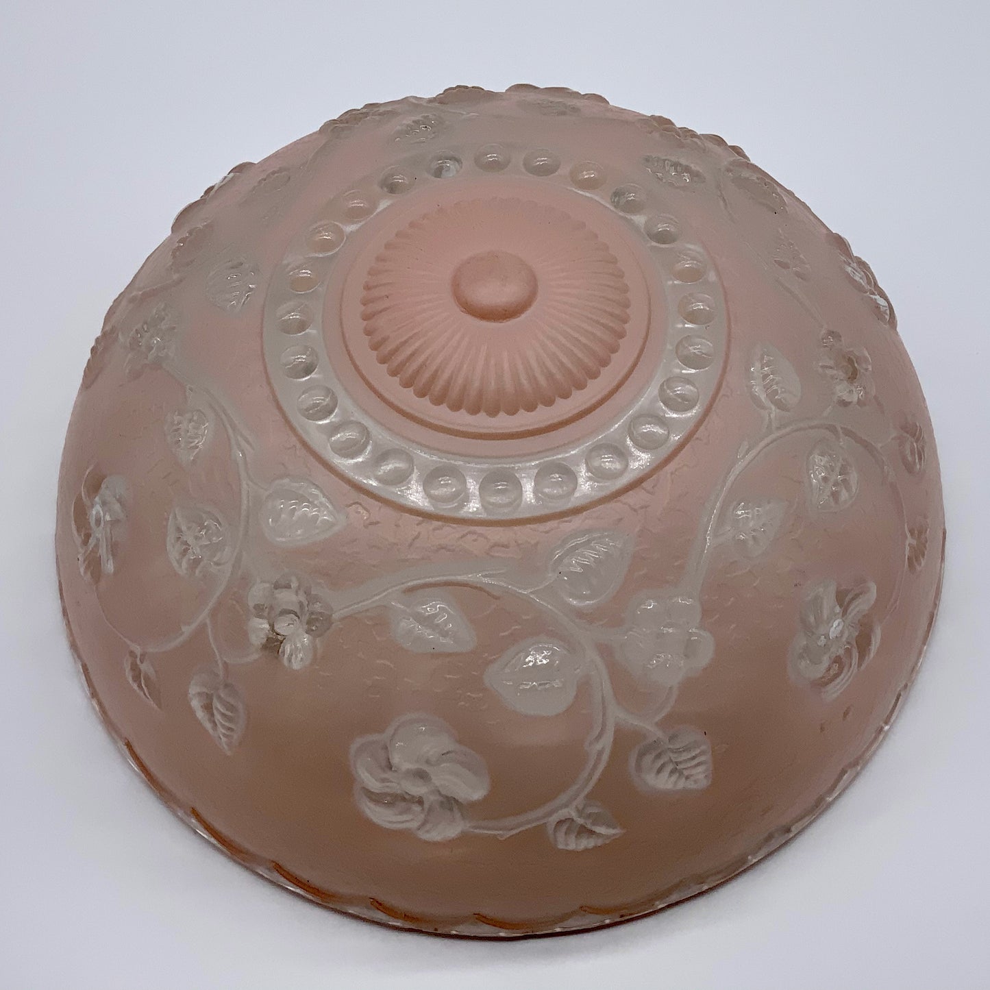 1945-1950's Post War Era Clear and Blush Pink Pressed Glass Ceiling Light Shade Features a center circular nipple style design adorned with a repeating flower and leaf pattern. Dusty pink is painted airbrushed on the outside and the embossed raised floral pattern is clear. 10.25 Diameter x 4" Deep Three Glass Hole Mounts No Chips or Cracks