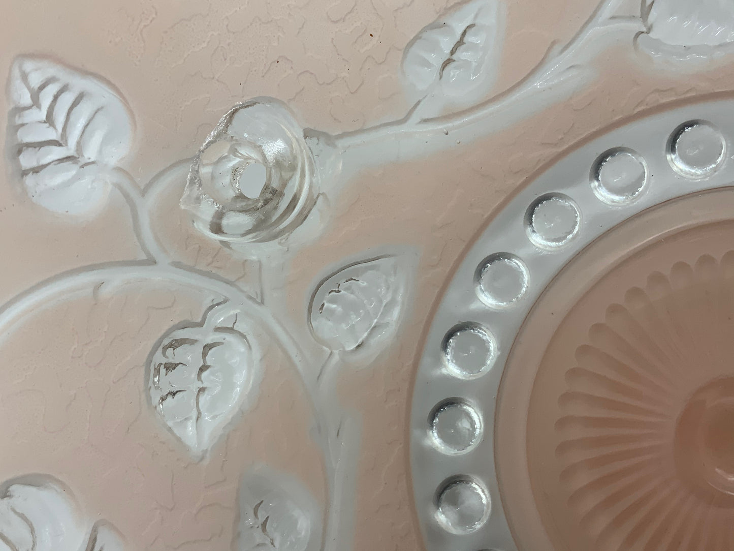 1945-1950's Post War Era Clear and Blush Pink Pressed Glass Ceiling Light Shade Features a center circular nipple style design adorned with a repeating flower and leaf pattern. Dusty pink is painted airbrushed on the outside and the embossed raised floral pattern is clear. 10.25 Diameter x 4" Deep Three Glass Hole Mounts No Chips or Cracks