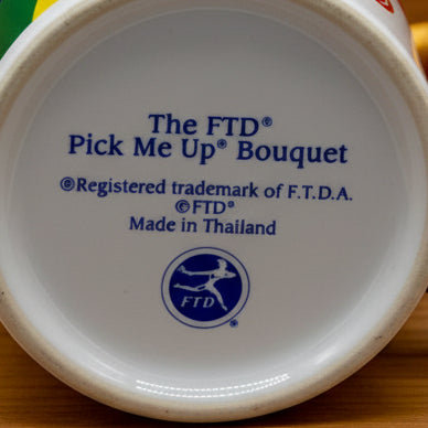Bottom view marked  FTD Pick Me Up Bouquet Copyright Registered Trademark of F.T.D.A. Copyright FTD Made in Thiand FTD Logo 
