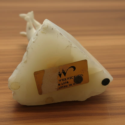 A vintage Marvin Wernick kinetic dolphin statue on a wire, displayed on a quartz marble base.