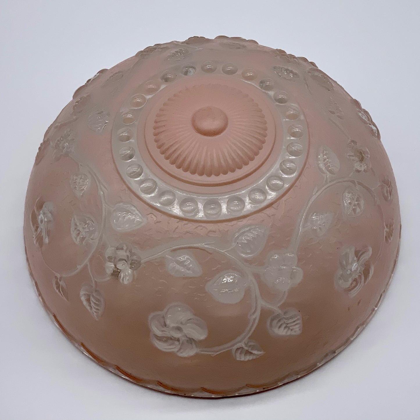 1945-1950's Post War Era  Clear and Blush Pink Pressed Glass Ceiling Light Shade Features a center circular nipple style design adorned with a repeating flower and leaf pattern. Dusty pink is painted airbrushed on the outside and the embossed raised floral pattern is clear.  10.25 Diameter x 4" Deep  Three Glass Hole Mounts  No Chips or Cracks