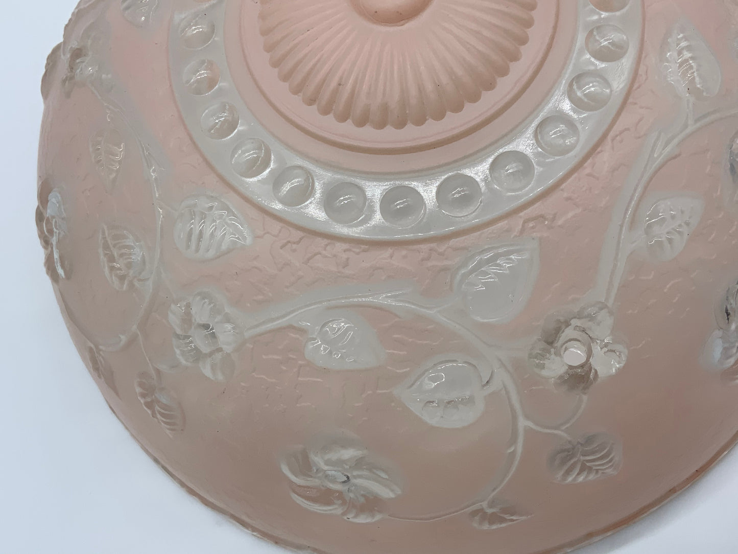 1945-1950's Post War Era  Clear and Blush Pink Pressed Glass Ceiling Light Shade Features a center circular nipple style design adorned with a repeating flower and leaf pattern. Dusty pink is painted airbrushed on the outside and the embossed raised floral pattern is clear.  10.25 Diameter x 4" Deep  Three Glass Hole Mounts  No Chips or Cracks