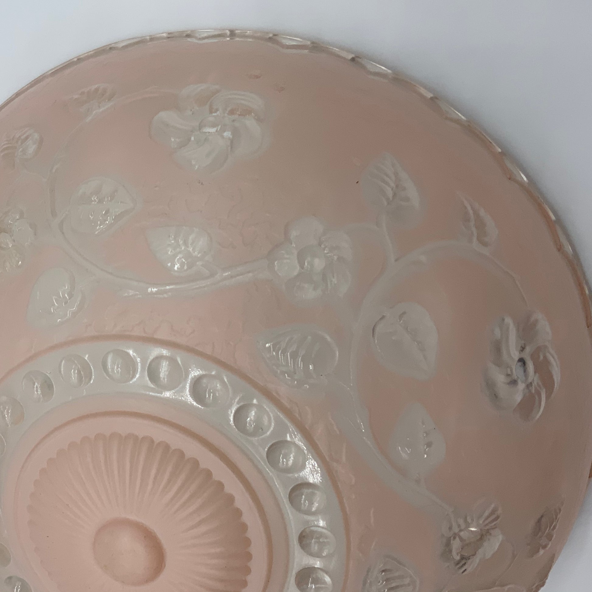 1945-1950's Post War Era  Clear and Blush Pink Pressed Glass Ceiling Light Shade Features a center circular nipple style design adorned with a repeating flower and leaf pattern. Dusty pink is painted airbrushed on the outside and the embossed raised floral pattern is clear.  10.25 Diameter x 4" Deep  Three Glass Hole Mounts  No Chips or Cracks