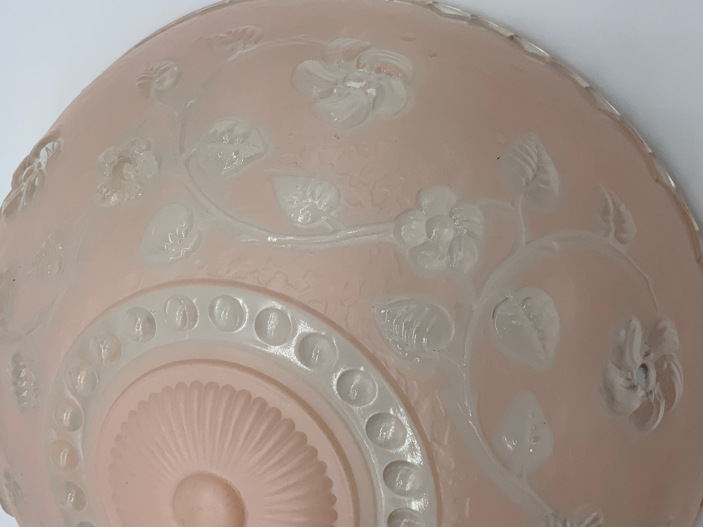 1945-1950's Post War Era  Clear and Blush Pink Pressed Glass Ceiling Light Shade Features a center circular nipple style design adorned with a repeating flower and leaf pattern. Dusty pink is painted airbrushed on the outside and the embossed raised floral pattern is clear.  10.25 Diameter x 4" Deep  Three Glass Hole Mounts  No Chips or Cracks