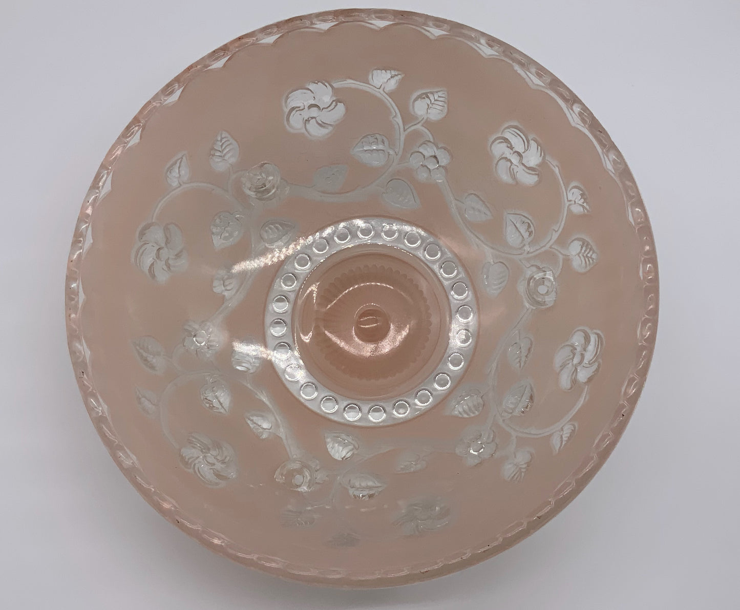 1945-1950's Post War Era  Clear and Blush Pink Pressed Glass Ceiling Light Shade Features a center circular nipple style design adorned with a repeating flower and leaf pattern. Dusty pink is painted airbrushed on the outside and the embossed raised floral pattern is clear.  10.25 Diameter x 4" Deep  Three Glass Hole Mounts  No Chips or Cracks